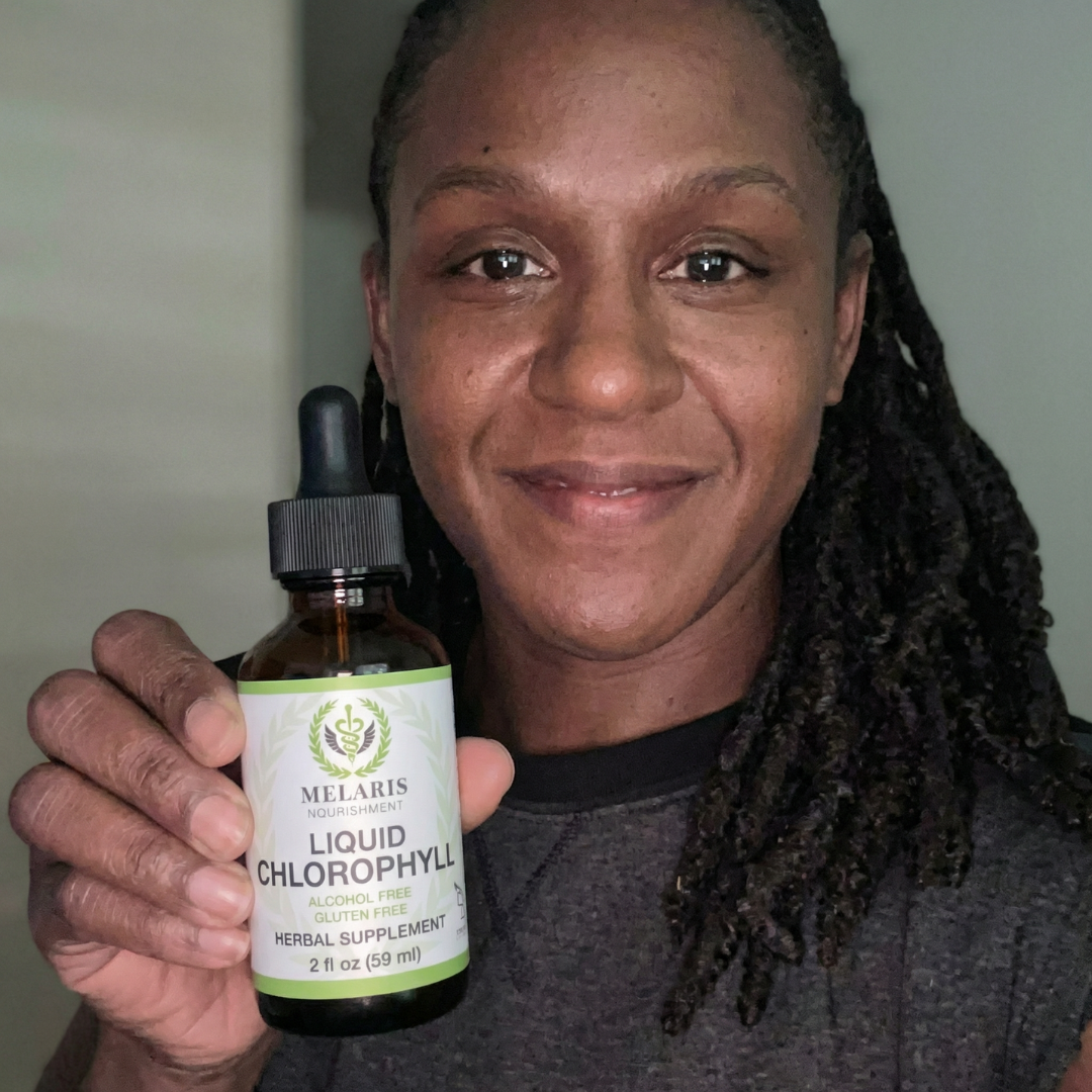 Woman smiling holding Melaris Liquid Chlorophyll bottle